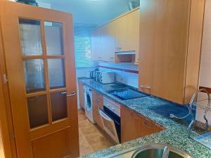 a kitchen with wooden cabinets and a counter top at Classypropety3 in Manilva