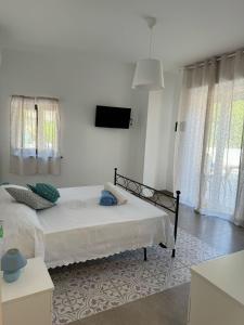 Ένα ή περισσότερα κρεβάτια σε δωμάτιο στο Le Suites di Teodoro
