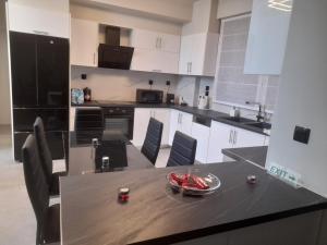 a kitchen with a table with a bowl of food on it at Maisonette in Marousi in Athens +16 photos