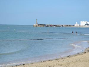 two people standing in the water at the beach at Beach Oasis Cottage - Uk48530 in Margate +2 photos