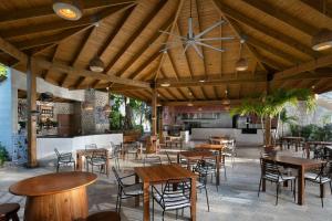 a restaurant with tables and chairs and a large wooden ceiling at Impressive Punta Cana - All Inclusive in Punta Cana