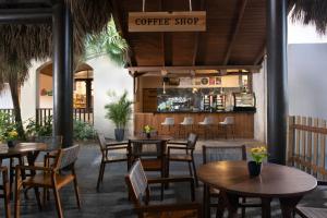 a restaurant with tables and chairs and a coffee shop at Impressive Punta Cana - All Inclusive in Punta Cana