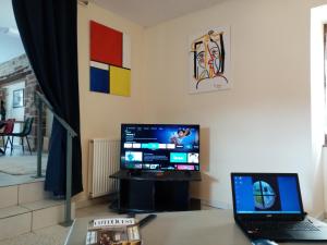 escritorio con ordenador portátil y monitor de ordenador en L'atelier, en Ligneyrac