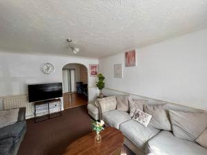 a living room with a couch and a table at Bull Double bed in shared house in Stifford +14 photos