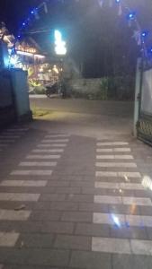 an empty parking lot at night with lights at Girl room 83300---70470 in Varkala