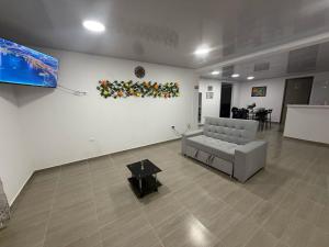 a living room with a couch and a table at Aparta hotel Brisas de salento in Salento