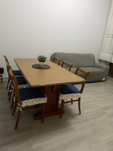 a dining room table with chairs and a couch at Casa Melly in Barletta +4 photos