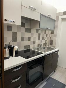a kitchen with a sink and a stove top oven at Casa Melly in Barletta