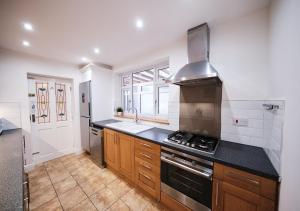 a large kitchen with a stove and a sink at Aspen, 3 Bedrooms with Parking in Birmingham