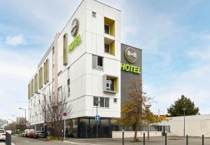 a white building with a hotel sign on it at B&B HOTEL Paris Est Bobigny Université in Bobigny +35 photos
