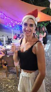 a woman wearing a santa hat holding a drink at Langkawi-Village Mix Dormitory in Pantai Cenang