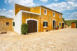 an orange and white building with a door at Fora Vila in Manacor
