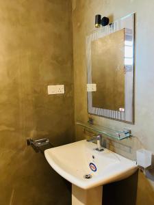 a bathroom with a sink and a mirror at Villa 66 Ahangama in Ahangama