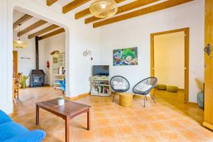 a living room with a blue couch and a table at Fora Vila in Manacor