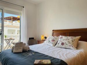 a bedroom with a bed with pillows and a balcony at Casa Encanto de Nerja by At Home costa del sol in Nerja