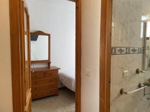a bathroom with a mirror and a dresser with a bed at Casa Encanto de Nerja by At Home costa del sol in Nerja +41 photos