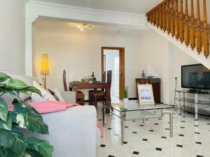a living room with a couch and a table at Casa Encanto de Nerja by At Home costa del sol in Nerja