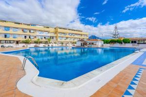 a large swimming pool in front of a hotel at Marina Palace with Swimming Pool in Adeje