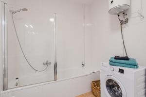 a bathroom with a shower and a washing machine at Marina Palace with Swimming Pool in Adeje +20 photos
