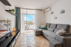 a living room with a couch and a large window at Marina Palace with Swimming Pool in Adeje