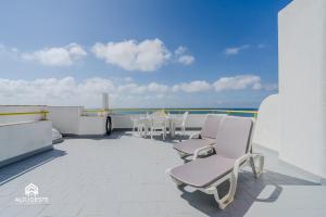 a balcony with two chairs and a table on a roof at Ericeira Panoramic Sea View Apartments in Ericeira