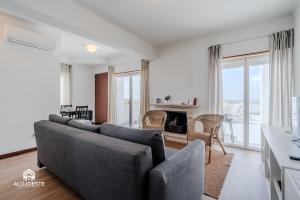 a living room with a couch and a table at Ericeira Panoramic Sea View Apartments in Ericeira