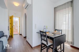 a dining room with a black table and chairs at Ericeira Panoramic Sea View Apartments in Ericeira