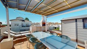 a patio with a table and chairs on a balcony at Casa NY - A Murcia Holiday Rentals Property in Roldán