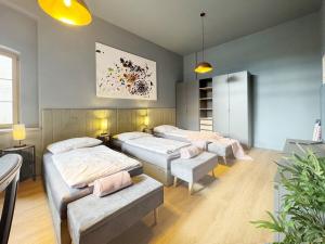 a room with three beds in it with at Platanenblick in Schönebeck an der Elbe in Schönebeck