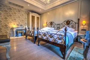 a bedroom with two beds and a desk in a room at MFB Tarabya Hotel in Istanbul