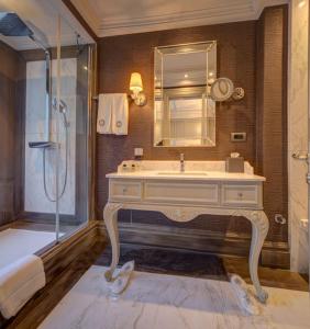 a bathroom with a sink and a shower at MFB Tarabya Hotel in Istanbul