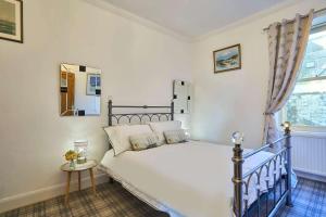 a bedroom with a white bed and a window at Host & Stay - The Aquamarine Weymouth Beach in Weymouth