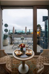 a table with food on it in front of a window at MFB Tarabya Hotel in Istanbul