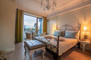 a bedroom with a bed and a large window at MFB Tarabya Hotel in Istanbul