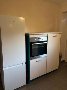 a kitchen with a refrigerator and an oven at Gîte de Raynal in Les Junies +24 photos