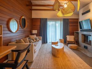 a living room with a couch and a fireplace at Kimera Lounge Boutique Hotel & Spa in Cıralı