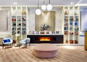 a living room with a fireplace and two chairs at Sercotel Hotel Europa in San Sebastián +74 photos