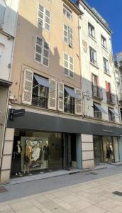 a store with mannequins in the window of a building at Le Saphir Central - Cosy - Gare in Mâcon