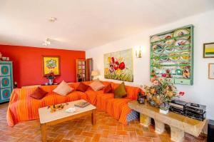 a living room with an orange couch and a table at Elegant Villa in Loulé with Private Pool in Loulé