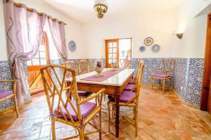 a dining room with a wooden table and chairs at Elegant Villa in Loulé with Private Pool in Loulé