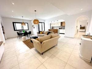 a living room with a couch and a table at Residence Jannet 2 Luxury Seaside 3bds in Hammamet Nord