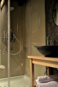 a bathroom with a glass shower with a sink at Halkidiki Luxurious Stonehouses in Psakoudia