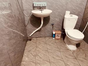 a bathroom with a toilet and a sink at Fish Farm Homestay in Yên Bái +53 photos
