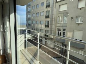a balcony with a view of a building at Casiola - Design apartment with sea views in Knokke-Heist