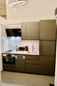 a kitchen with a sink and a stove at Studio Apartment - 5 min from City Center with AC in Budapest