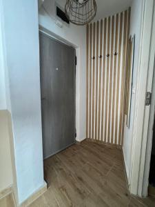 an empty room with a door and wooden floors at Lara Residence in Băile Herculane +2 photos