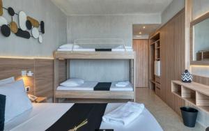 a small room with two bunk beds in it at Black & White Resort in Xylokastro