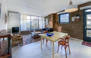 a living room with a table and chairs at Bergenhuisje in Bergen aan Zee
