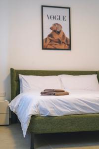 a bedroom with a bed with a picture of a dog at Egħżien Suite A2 Access to Tranquil Shared Pool in Xagħra +42 photos