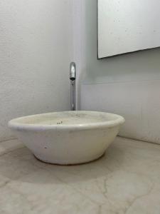 a white bowl sitting on the floor in a room at Depto 3 in Río Cuarto +4 photos